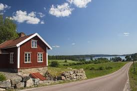 A classic Swedish red countryside cottage by a lake